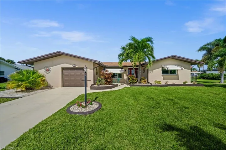 Tropical landscaping and an inviting front entrance.