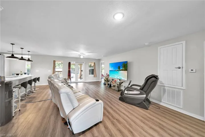 Living room featuring ceiling fan, hardwood / wood-style flooring, and french doors