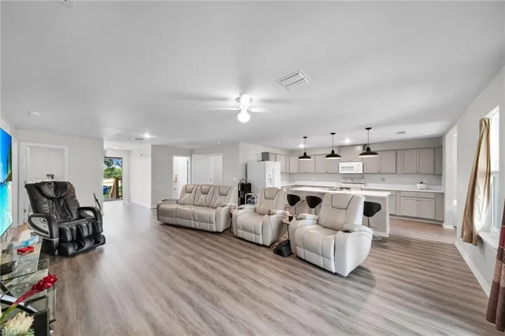 Living room featuring ceiling fan and light hardwood / wood-style flooring