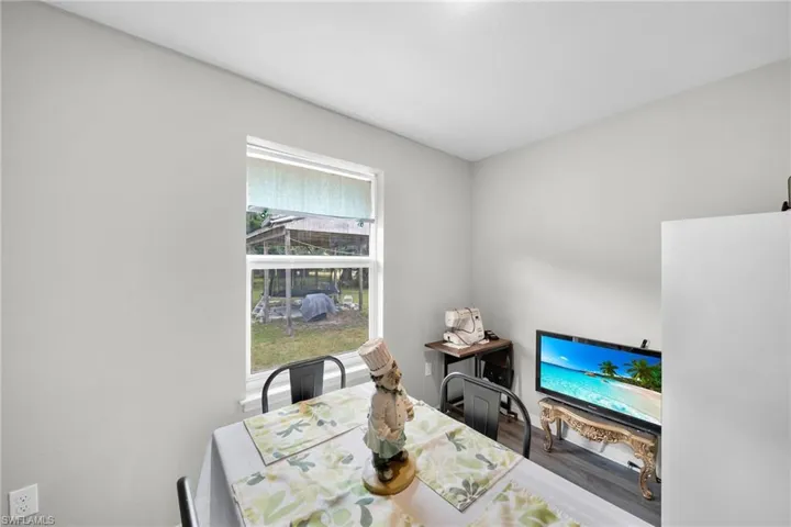 Dining space with a wealth of natural light and hardwood / wood-style floors