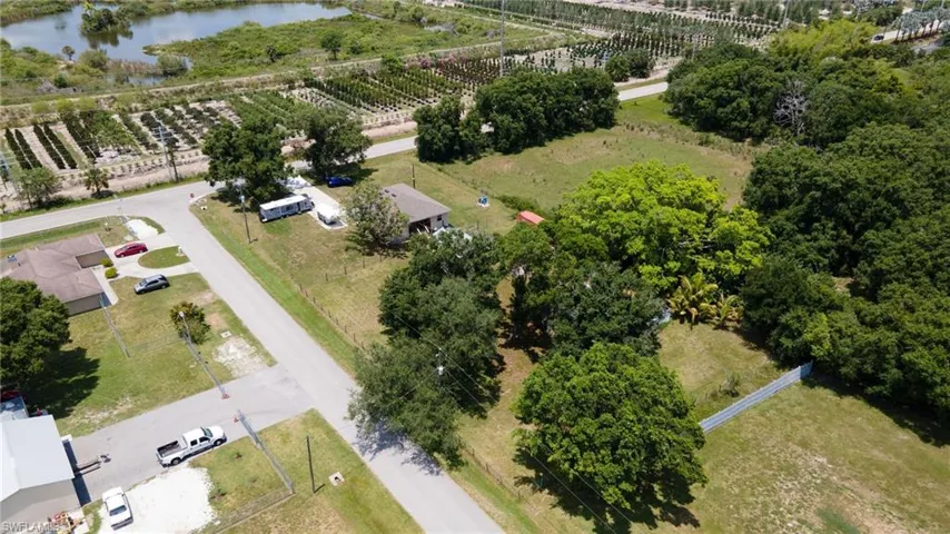 Birds eye view of property with a water view