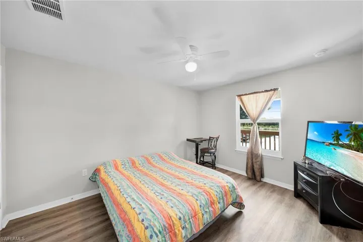 Bedroom featuring ceiling fan and wood-type flooring