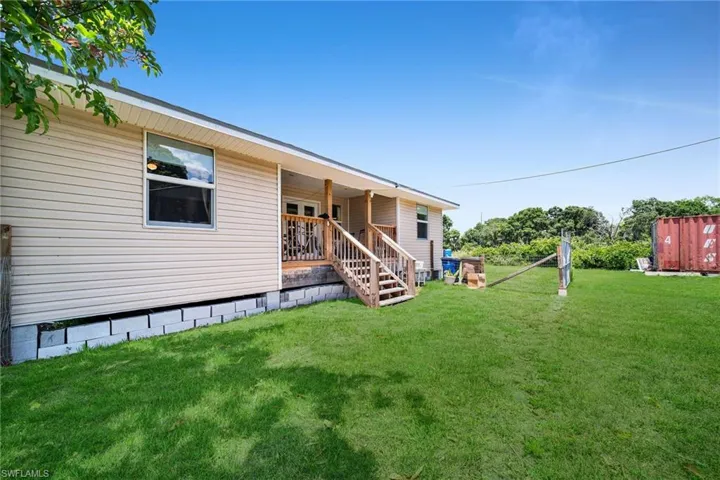 Back of house featuring a lawn