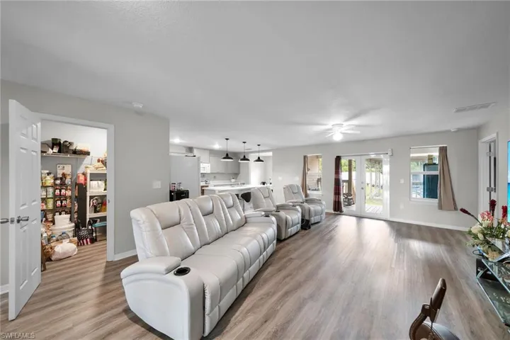 Living room featuring ceiling fan, light hardwood / wood-style flooring, and french doors