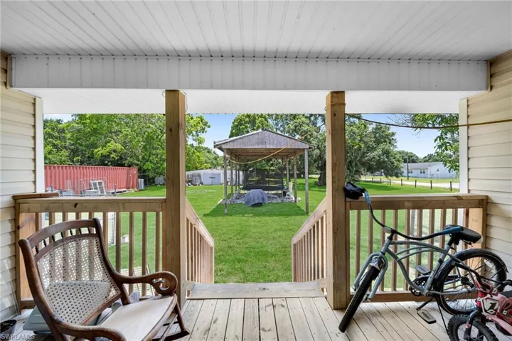 Wooden deck featuring a lawn and a gazebo