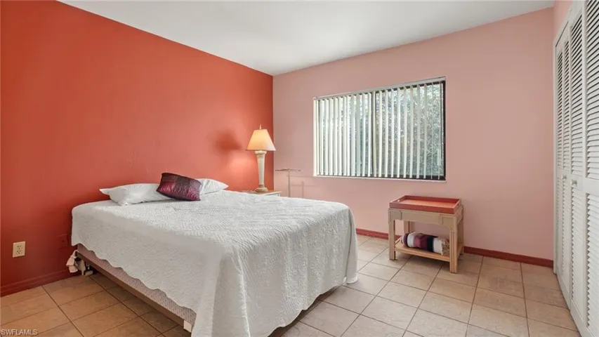 Tiled bedroom with a closet