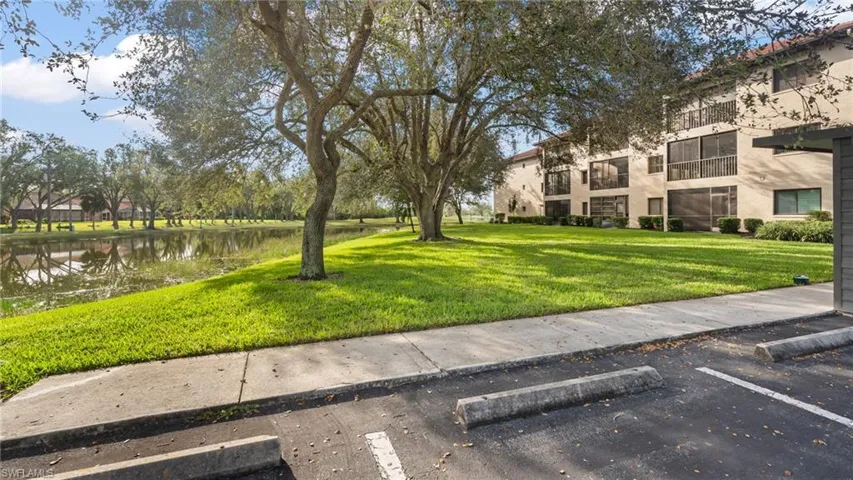 View of property's community with a yard and a water view