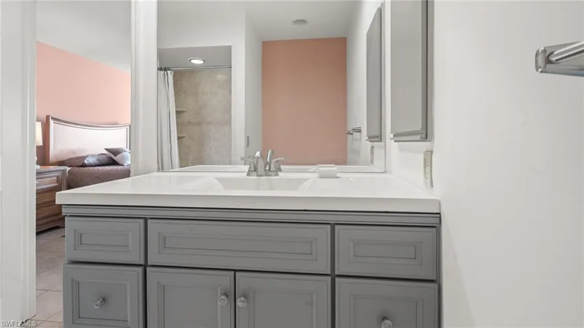 Bathroom with tile patterned flooring, vanity, and a shower with shower curtain