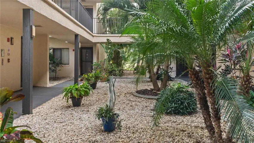 View of yard with a balcony
