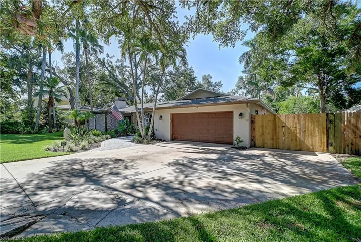 Ranch-style house with a front lawn and a garage
