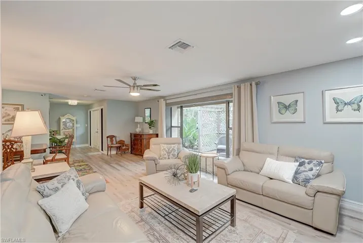 Living room with ceiling fan and light luxury vinyl plank flooring