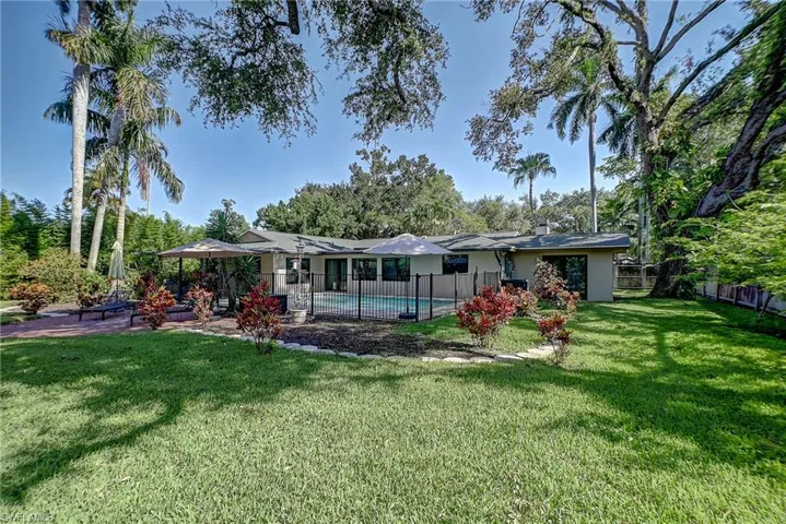 fenced backyard with enclosed pool