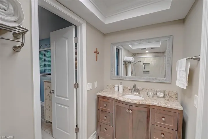 Jack-and-jill bathroom with large vanity and tray ceiling