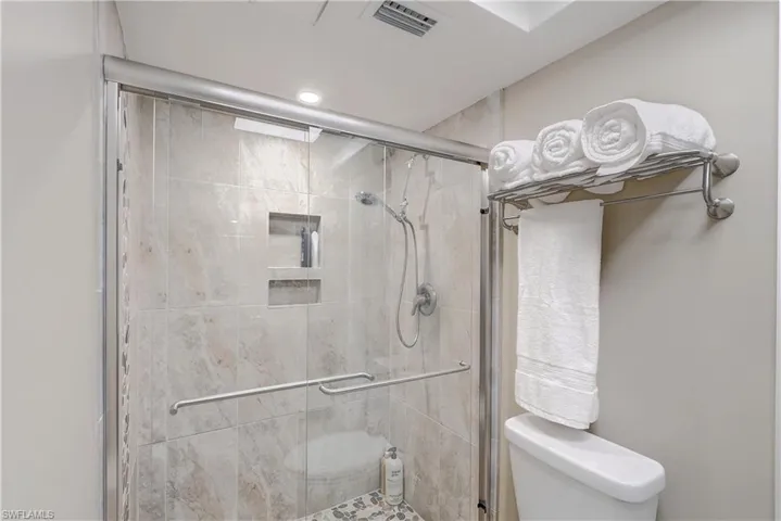 Bathroom with an enclosed shower and toilet