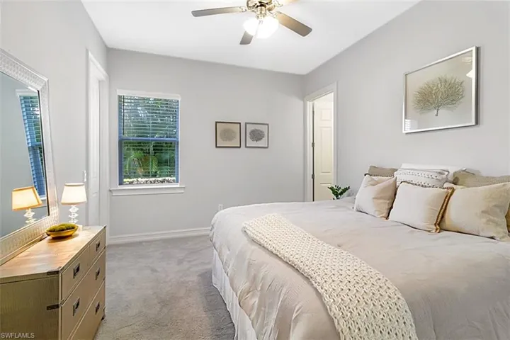 Karastan carpeted bedroom with ceiling fan and ensuite bathroom