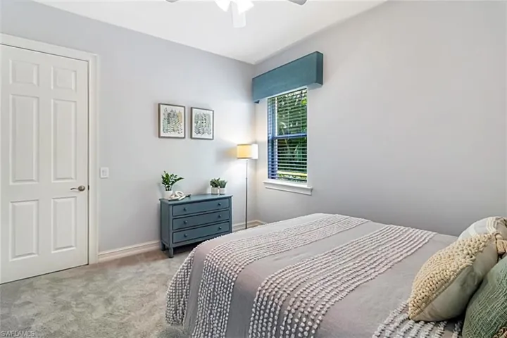 Bedroom with Karastan carpet and ceiling fan