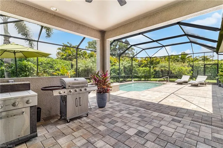 View of lanai featuring plumbed in grilling area