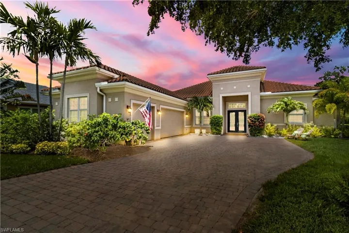 Home featuring pavers and a front yard