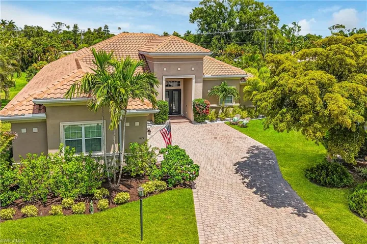 Home featuring pavers and a front yard