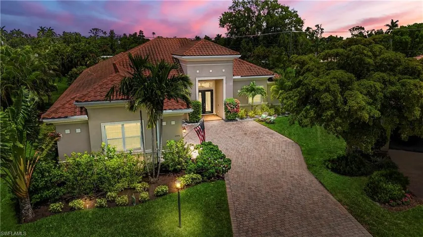 Home featuring pavers and a front yard