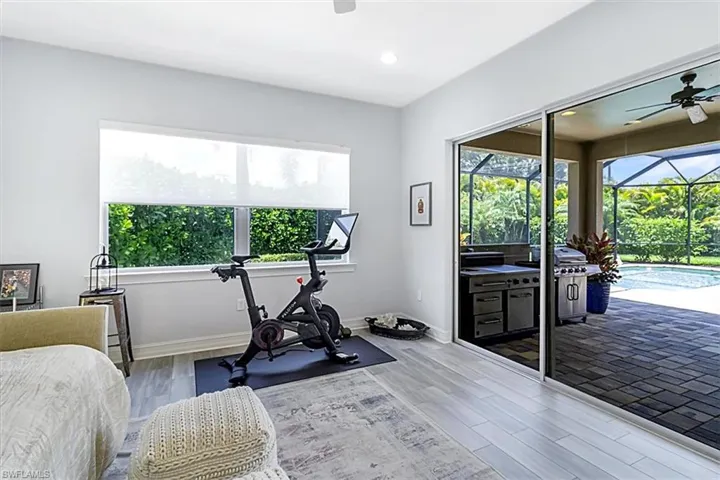 Den with ceiling fan and cortex flooring