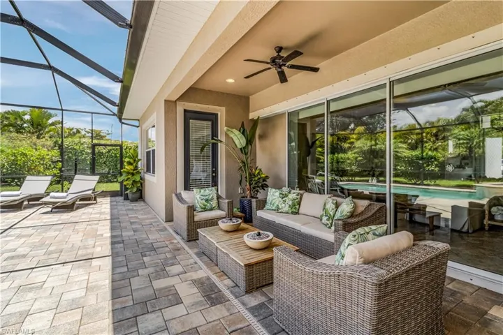 View of terrace featuring ceiling fan, screen enclosure, and an outdoor patio area