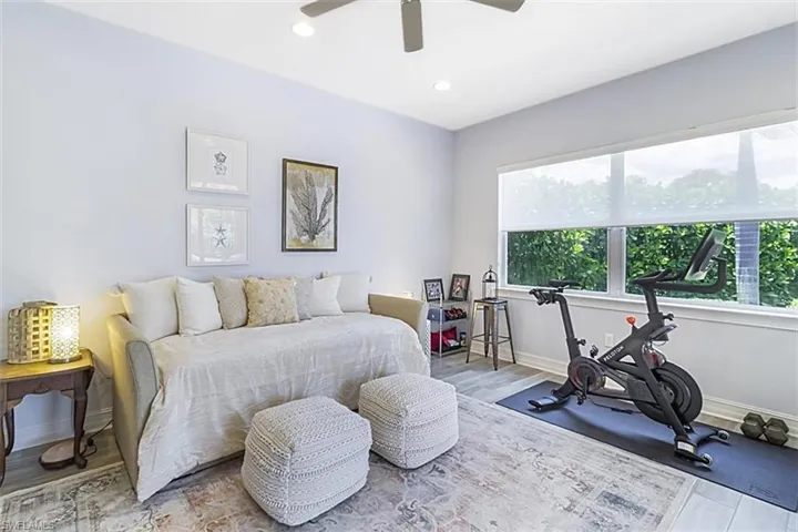 Den with ceiling fan and cortex flooring
