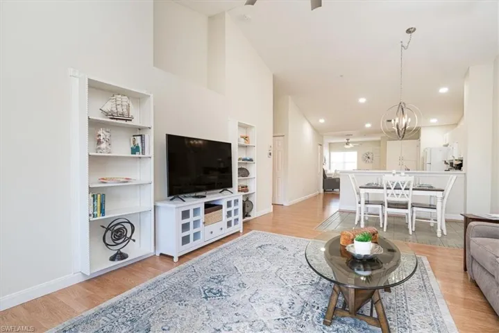 Living room featuring built in shelving & Art Niche