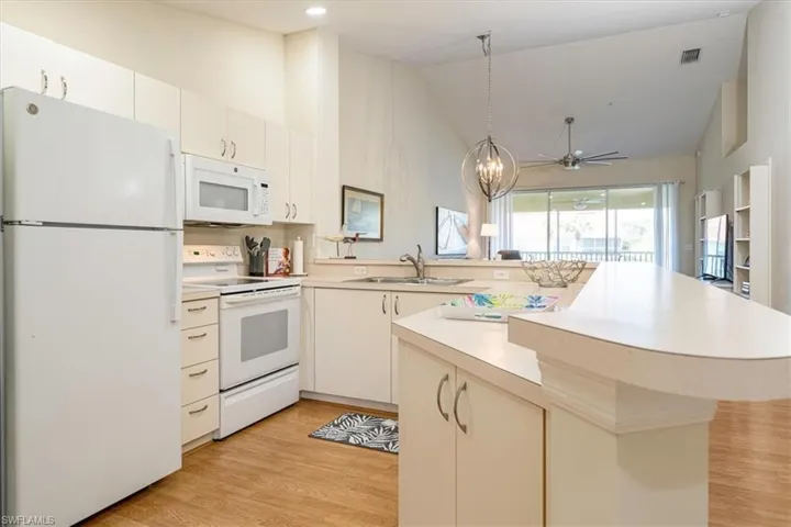 Kitchen with white appliances, pantry & breakfast bar