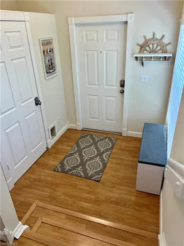 Doorway with hardwood / wood-style flooring