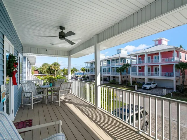 FRONT OF HOUSE COVERED PORCH  AND LANAI WITH BAY VIEWS.