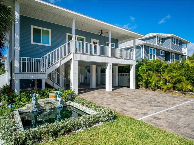 TASTEFUL LANDSCAPINGACCENTED BY A FLORIDA STYLE KEY WEST HOME.