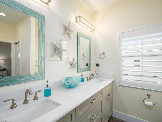 MASTER BATH WITH HIS AND HER SINKS.