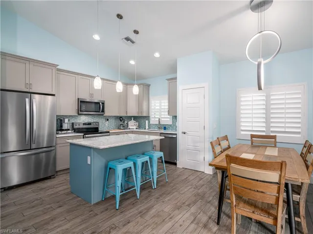 VIEW OF DINING AREA AND KITCHEN ISLAND.