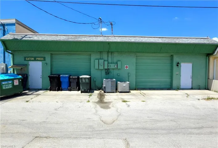 Garage featuring cooling unit and concrete driveway