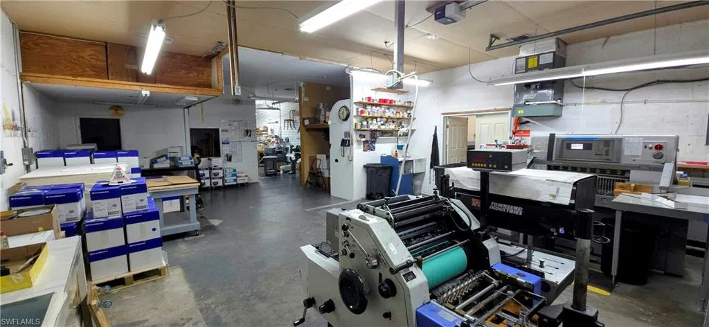 Garage featuring a workshop area and a garage door opener