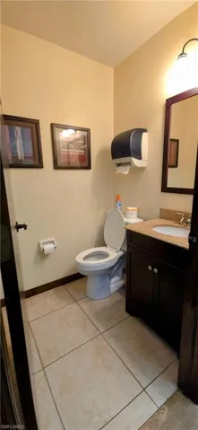 Bathroom with tile patterned floors, vanity, and toilet