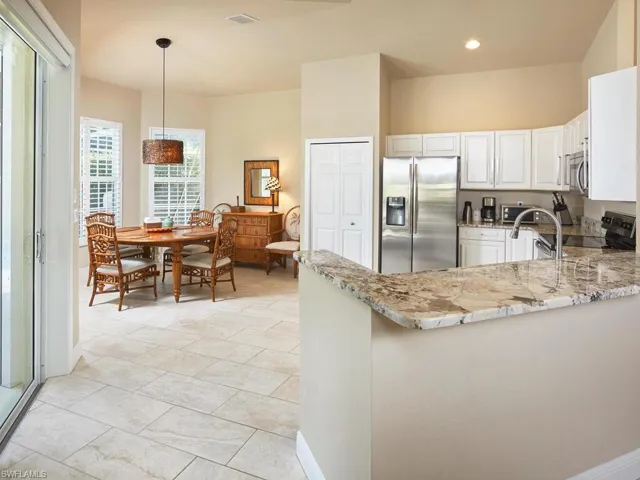 Dining area overlooks lanai/pool area.