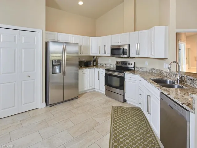 White cabinetry, spacious pantry and stainless appliances.