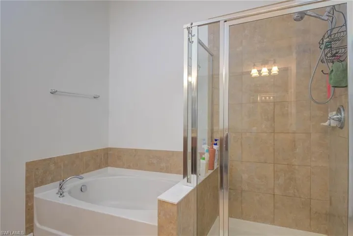 Bathroom featuring a stall shower and a garden tub