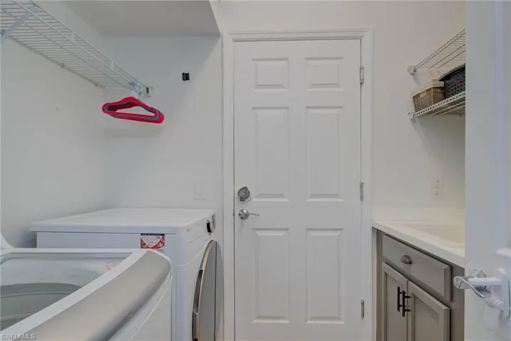 Laundry area with cabinet space and washer and clothes dryer