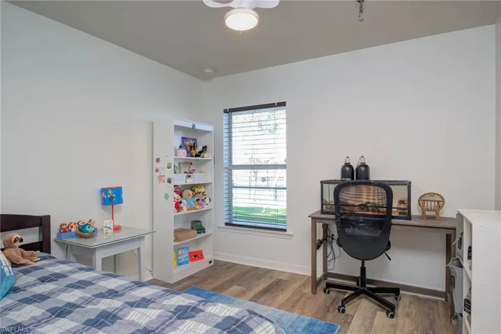 Bedroom with baseboards and light wood-style floors