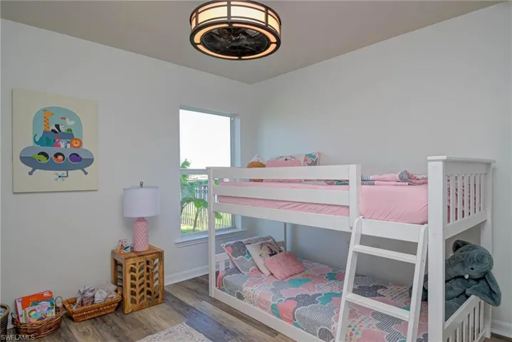 Bedroom with baseboards and wood finished floors