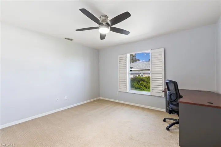 Bedroom with light colored carpet and ceiling fan