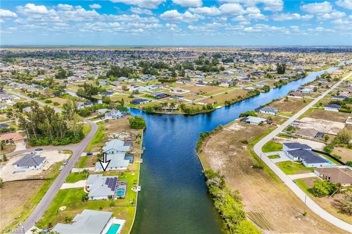 Aerial view of residential area featuring a large body of water