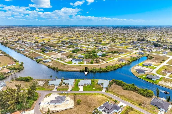 Aerial perspective of suburban area with a nearby body of water