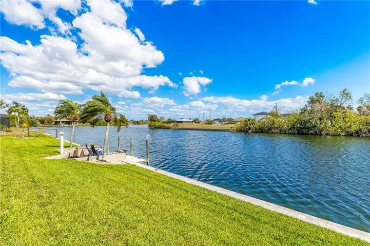 Dock featuring a lawn and a water view
