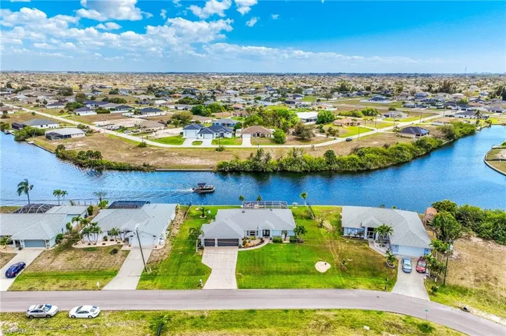 Aerial perspective of suburban area featuring a large body of water