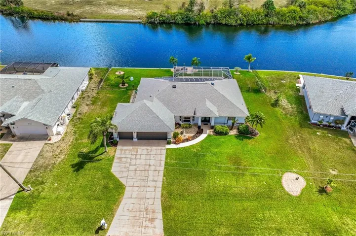 Aerial view of property and surrounding area featuring a large body of water