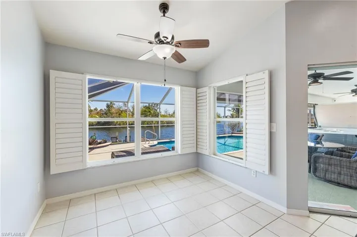 Unfurnished Breakfast room featuring a ceiling fan, a water view, and vaulted ceiling
